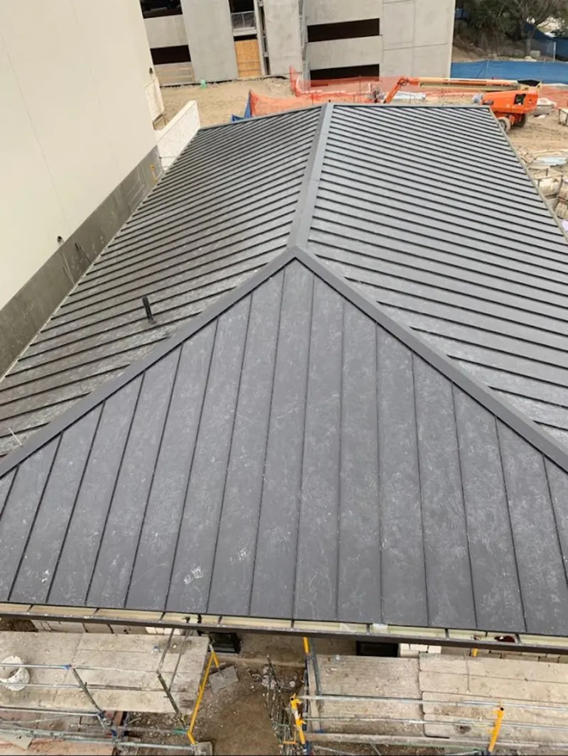 Commercial metal roof construction with crane equipment in Lancaster